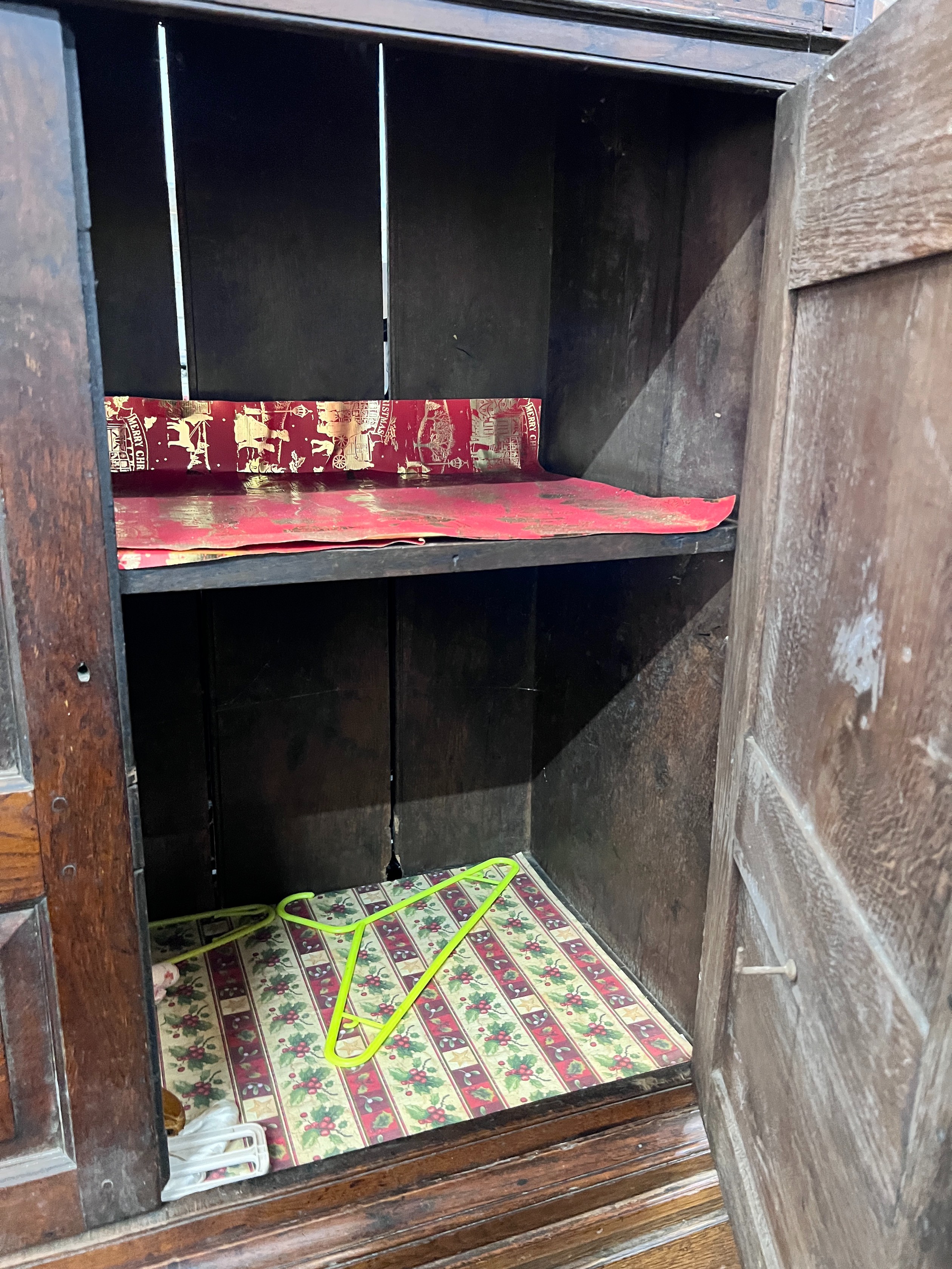 A George III oak press cupboard with two panelled doors over five drawers, width 111cm, depth 53cm, height 186cm *Please note the sale commences at 9am.